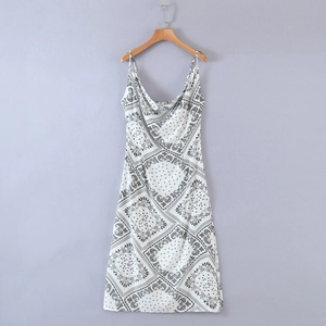 Detail of cowl neck summer dress with black paisley pattern on light woven fabric