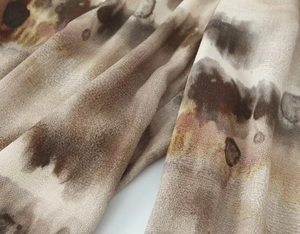 Close-up of artistic abstract tie-dye fabric with smooth texture and ink-wash pattern