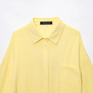 Women's light yellow linen cotton shirt with roll-up sleeves and front pocket
