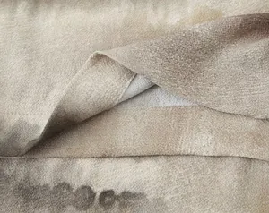 Detailed macro view of tie-dye fabric texture with professional stitched hem and brown tones