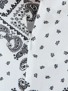 Detail of paisley print dress fabric with white invisible zipper and twill texture