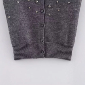 Grey knit short sleeve top with sparkling rhinestones and matching buttons detail