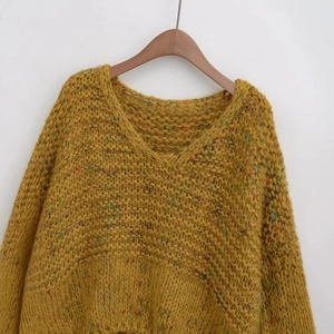 Ginger V-neck chunky knit sweater featuring colorful speckled yarn details on wooden hanger