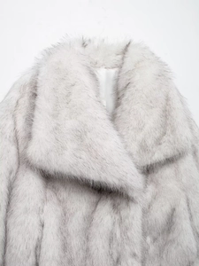 Close-up detail of soft gradient faux fur texture on elegant wide collar coat
