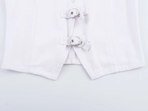 Detail of white denim vest featuring metallic silver buckle closures and twill fabric texture