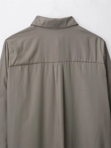 Detail of taupe shirt back showing the yoke structure and fine stitching craftsmanship