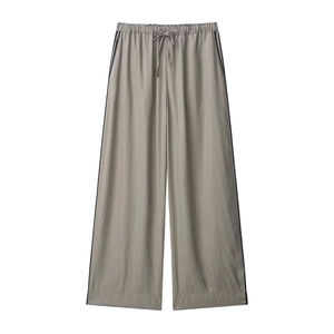 Detail of taupe wide-leg trousers featuring elastic waistband and black side stripes