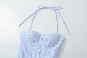 Detailed view of light blue striped halter neck top with white decorative buttons
