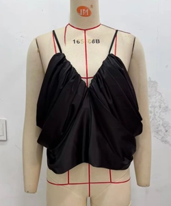 Close-up of black satin pleated camisole with deep V-neck and delicate straps details