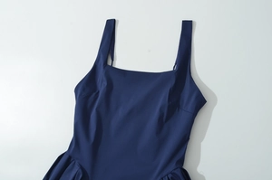 Detail view of navy blue square neck sleeveless dress with smooth woven texture