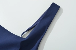 Detail of navy blue dress showing dual shoulder strap design with silver metal adjusters