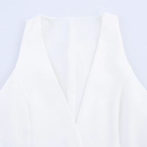 Detailed close-up showing the deep V-neckline and stitching on the white mini dress