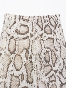 Detailed close-up of high-waist faux snakeskin print trousers with back pocket detail