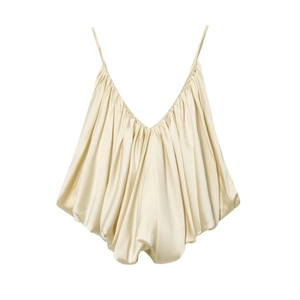 Detailed view of champagne satin camisole top featuring delicate pleats and a glossy finish