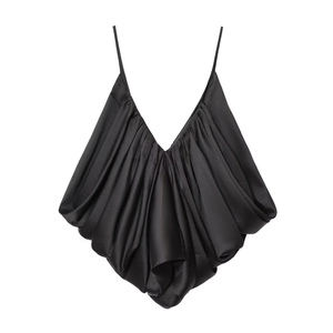 Detailed close-up of a black satin camisole featuring intricate tiered pleats and slim straps