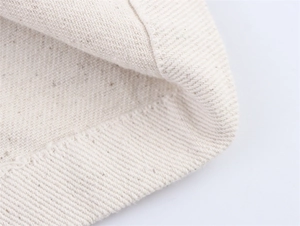 Detailed close-up showing thick cream-colored twill fabric texture and reinforced stitching