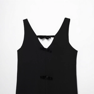 Elegant black V-neck sleeveless dress featuring velvet bows and ribbed knit texture