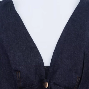 Dark blue denim V-neck top with vintage metal button and contrast orange stitching