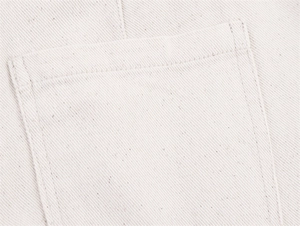 Close-up of heavy cotton canvas fabric showing durable twill weave and precise stitching details