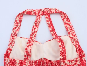 Detail of red floral top with hollow-out embroidery and crisscross shoulder straps