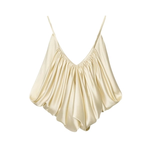 Detailed view of champagne satin camisole featuring layered pleats and silky texture