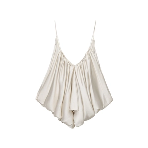 Detail of champagne satin camisole featuring delicate pleats and a draped silhouette