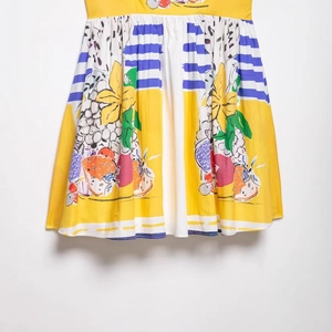 Short yellow and white fruit print A-line skirt with vibrant floral and grape patterns