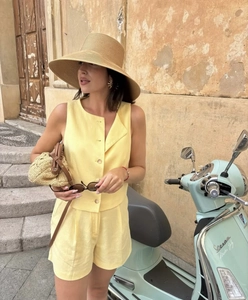 Detail view of light yellow linen sleeveless vest and shorts set for summer vacation wear