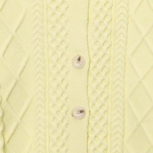 Pale yellow cable knit sweater with marble-textured buttons and soft twisted weave texture