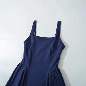 Minimalist navy blue sleeveless dress with square neck and pleated skirt in flat lay view