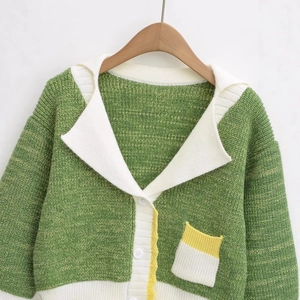 Green knit cardigan with large white collar and yellow wavy trim accents