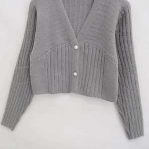 Classic grey V-neck knit cardigan for women with elegant pearl buttons and ribbed texture