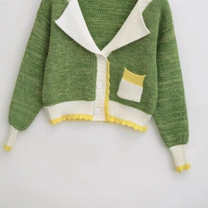 Green chunky knit V-neck cardigan with white contrast collar and yellow scalloped trim