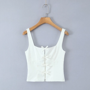 Detailed view of white camisole top featuring four delicate bows on square neckline
