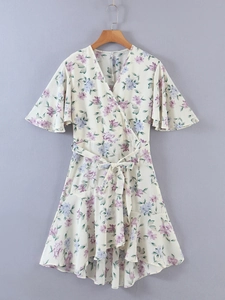 Detail showing the floral chiffon dress with ruffled short sleeves and a V-neckline wrap