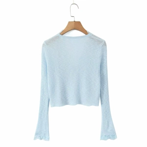 Close-up of light blue ribbed knit cardigan with lace-trimmed bell sleeves
