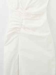 Detail view of the elegant ivory white midi dress featuring ruched pleats and side slit