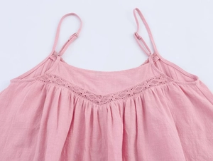 Detail of pink cotton top showing V-neck crochet lace and adjustable thin straps