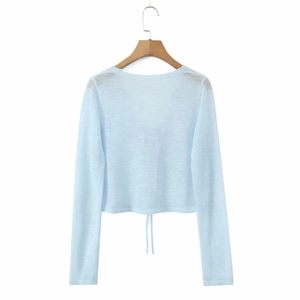 Detail of light blue cropped cardigan featuring adjustable drawstring hem and thin knit fabric