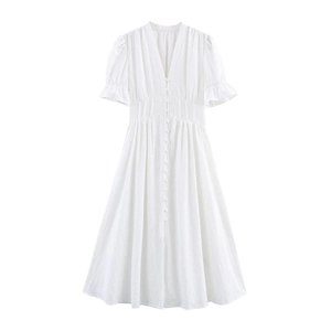 Close-up of white French embroidery details, V-neckline and buttons on cotton midi dress