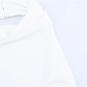 Detail shot of the back neck button closure and draped cowl neck design on white dress