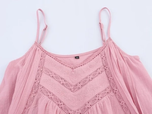 Close-up of light pink cotton camisole with lace embroidery and adjustable straps