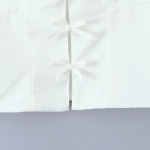 Women's white camisole top featuring delicate front bow ties and clean seam detail