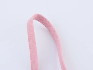 Macro shot of pink cotton canvas fabric handle with detailed stitching and fine texture