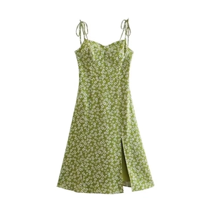 Close-up of green daisy print dress featuring thin straps and a side slit detail