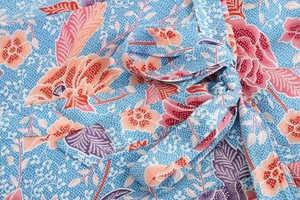 Détail de la ceinture à nouer sur la robe bleu clair à fleurs et pois blancs