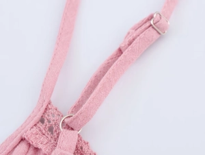 Detail of pink cotton-linen top showing adjustable shoulder straps and lace crochet trim