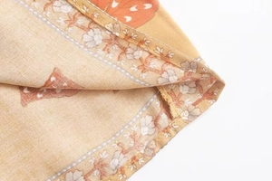 Detailed macro view of cotton fabric with floral and orange butterfly prints