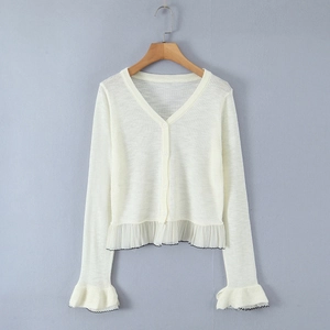 Elegant white V-neck cardigan featuring ruffled cuffs with contrasting black trim details