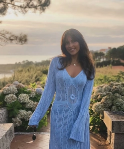 Detail of light blue crochet knit dress with intricate hollow geometric patterns